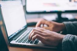 hands typing on a keyboard